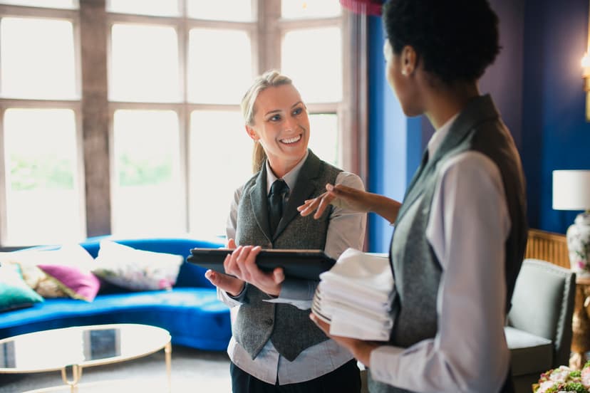 Two hotel workers chatting as the get ready to go to work