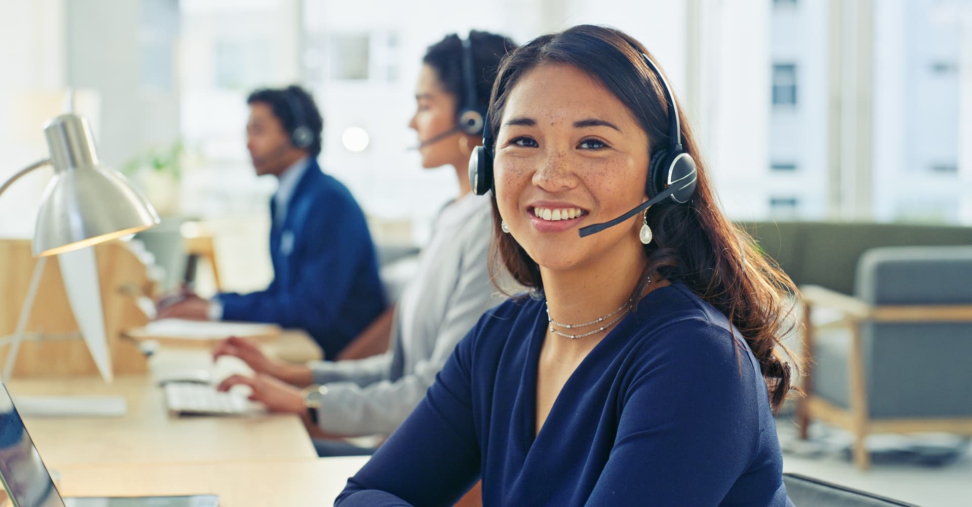 Female with headset looking directly at the camera