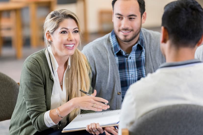 Female looks empowered leading a conversation with two other individuals present