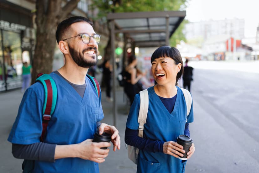 Two people laughing on their way to work