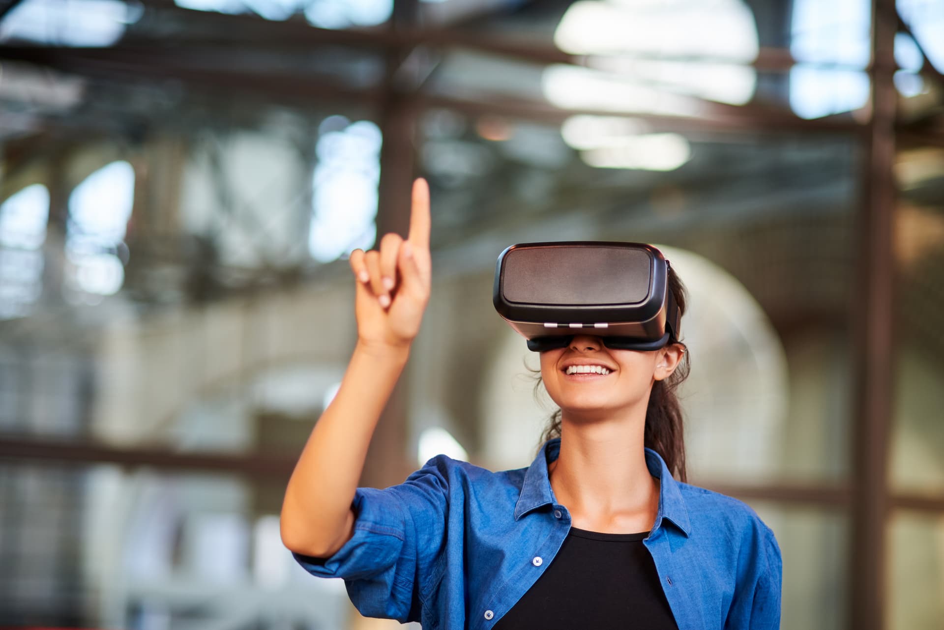 Person pointing in the air while engaging in a VR headset experience