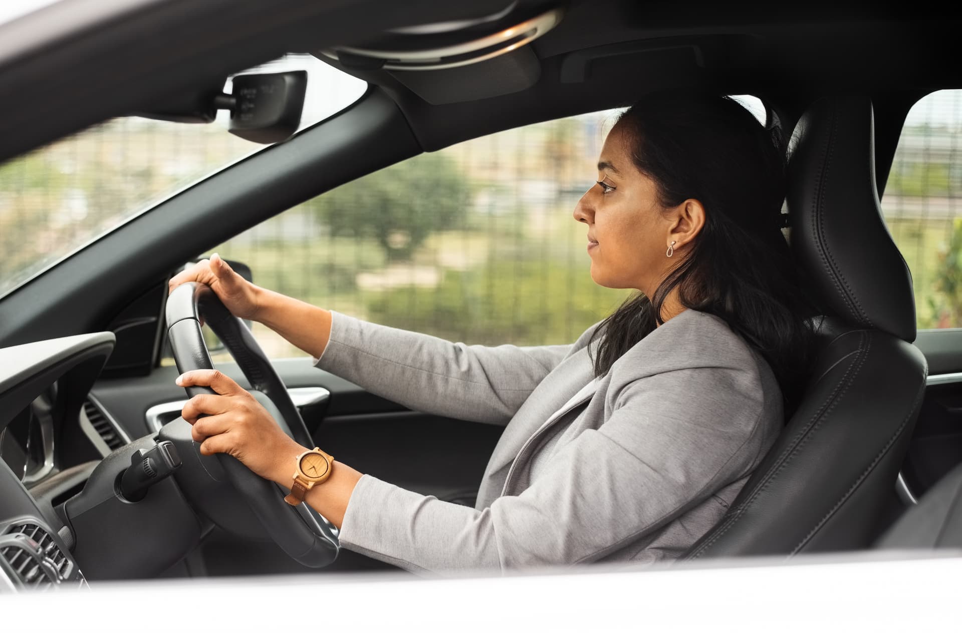 Corporate women driving to work in their car