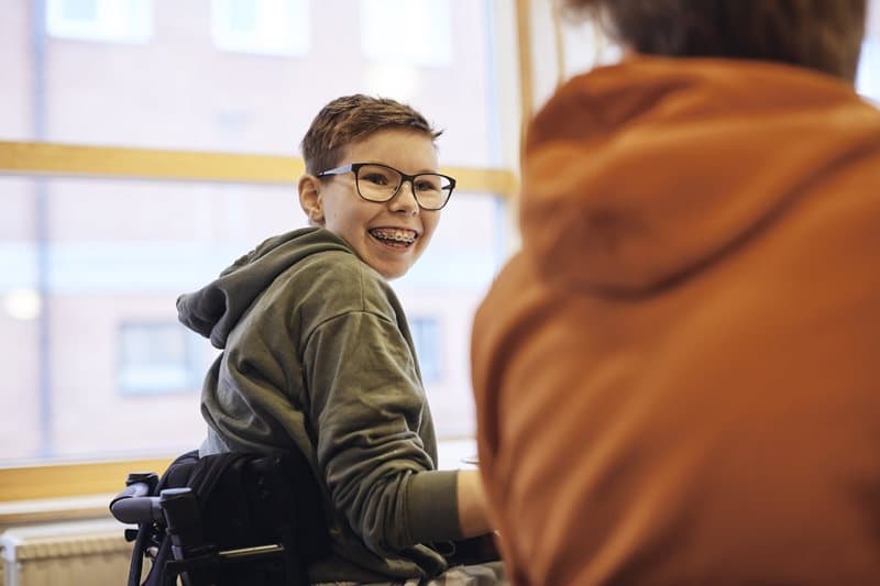 smiling student in wheelchair