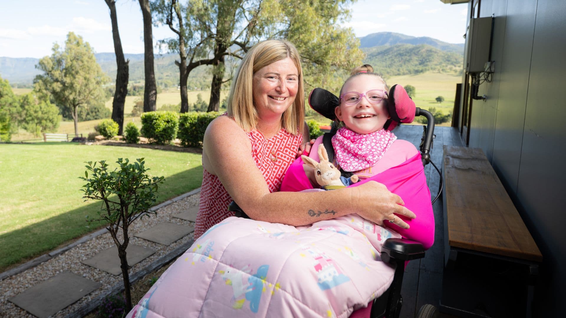 jessica-holding-emily-wheelchair-outdoors