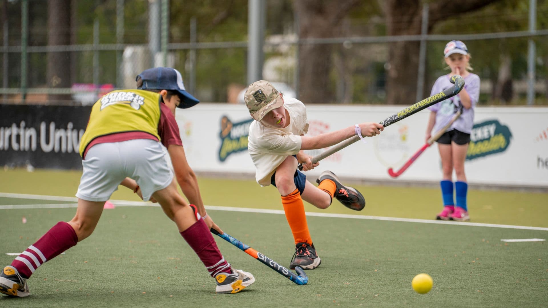 Kids playing hockey at an APM and Hockey Australia inclusive community event
