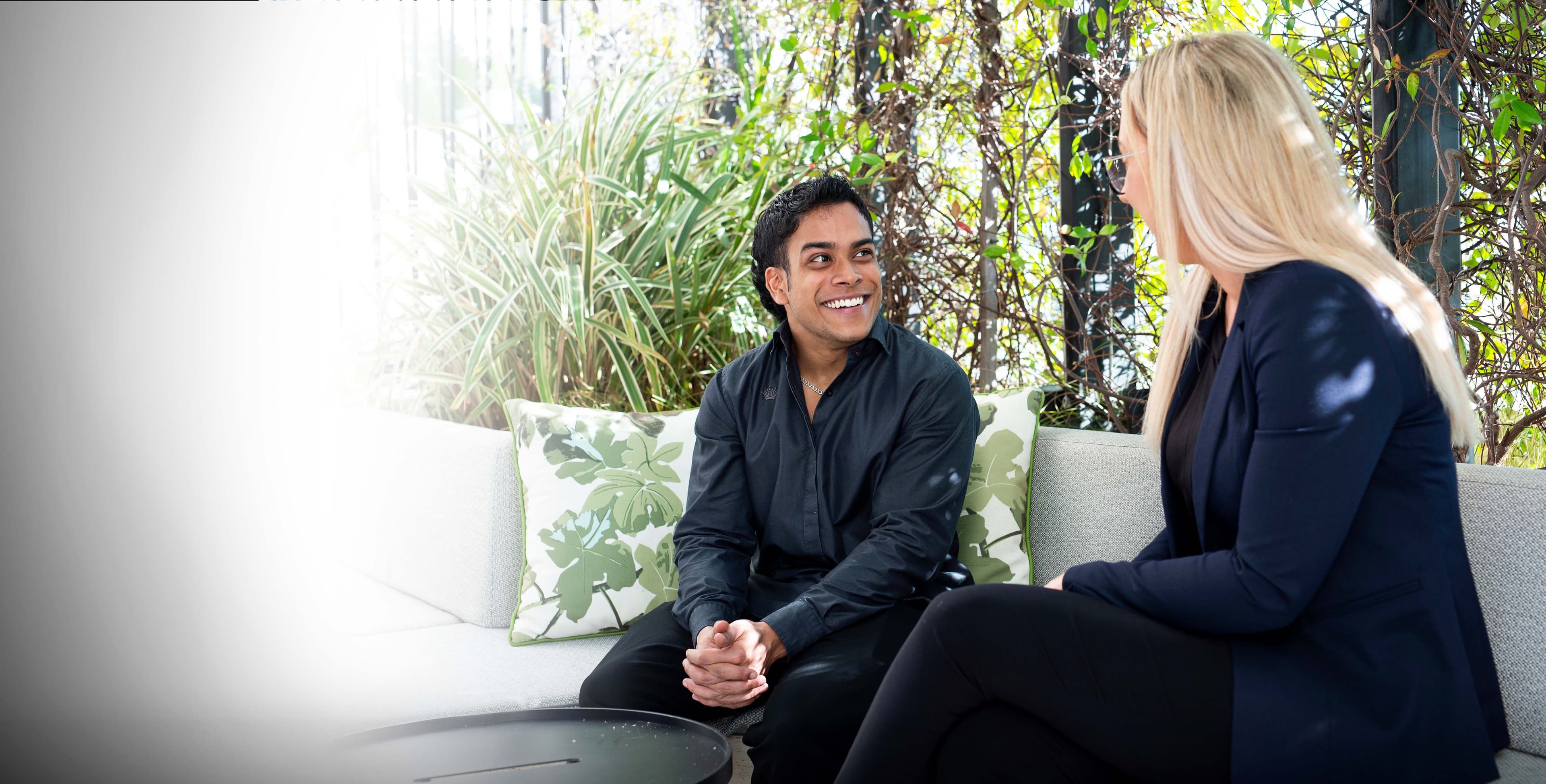 A man who is searching for work discussing his health condition with an APM consultant
