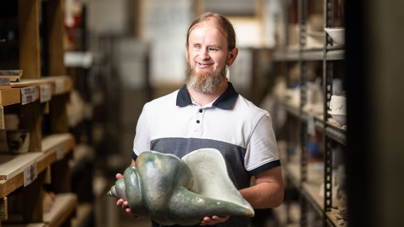 Ben holds a sculpture of a shell