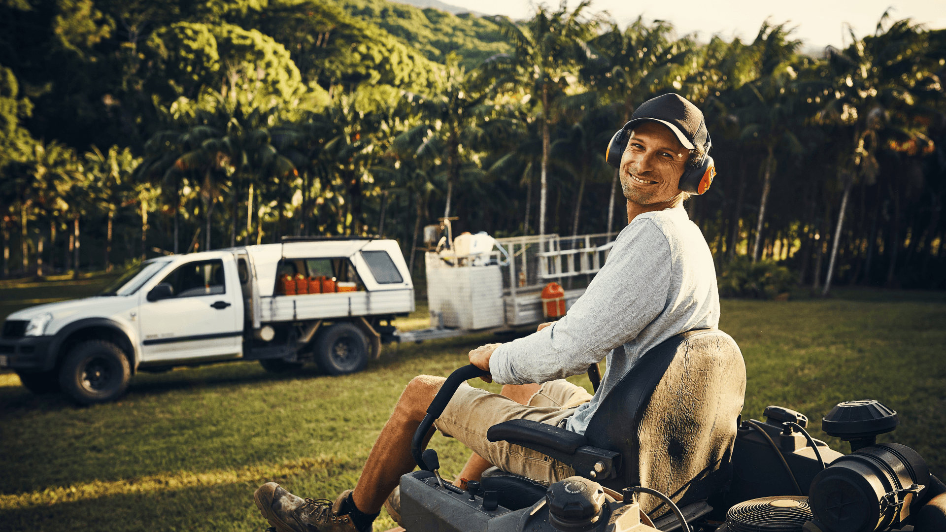 Man operating lawn mower smiling