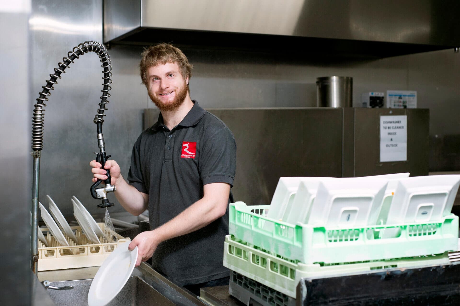 Bryn smiling in the hotel kitchen where he works