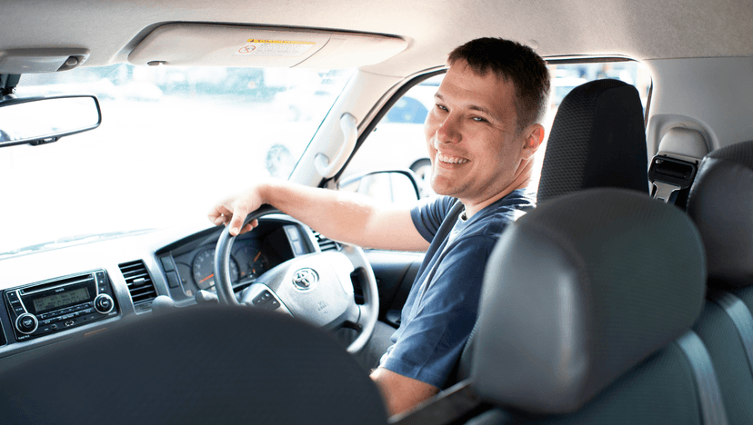 Participant Alexander smiles from the drivers seat