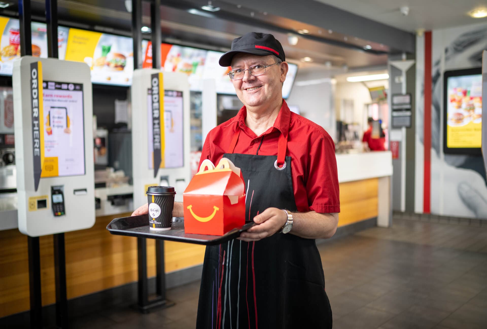Darren smiling at McDonald's in his work uniform