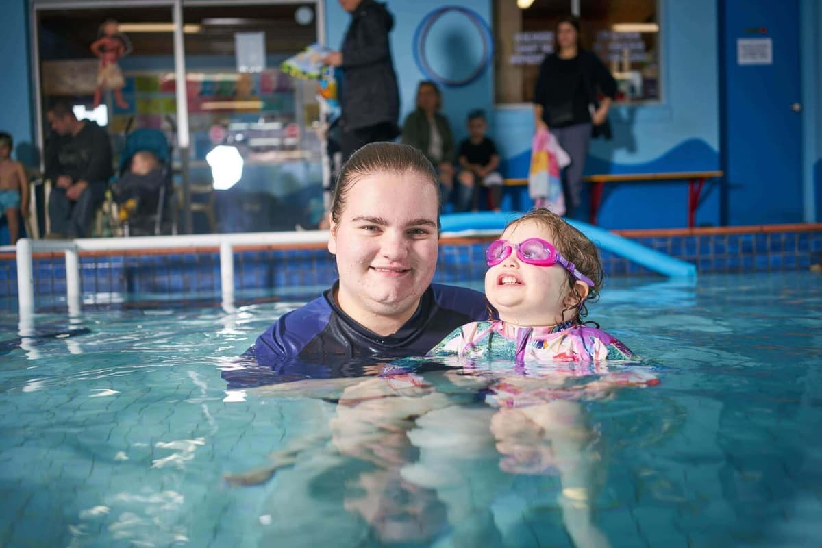 Maddy with swimming student in pool