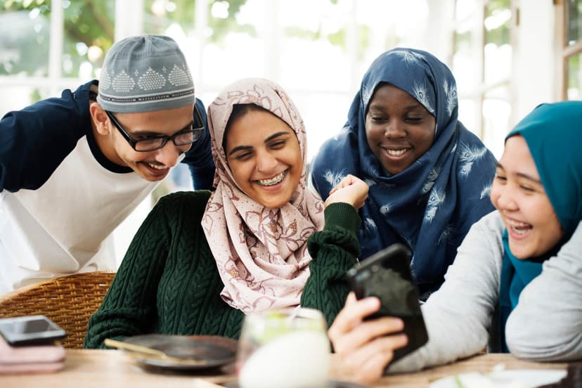culturally diverse group of people smiling at phone