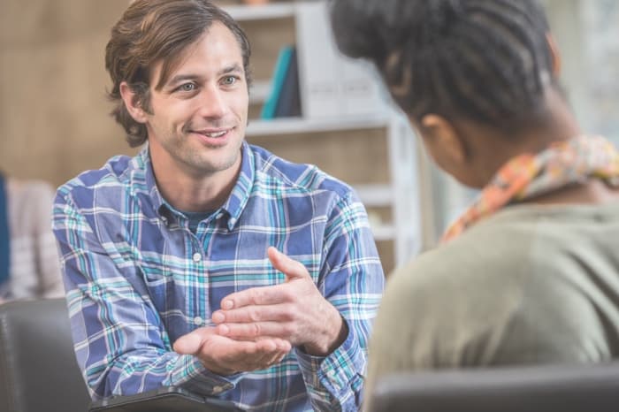 Male participant talks with a counsellor
