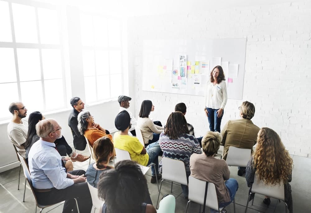 Class room learning from a teacher standing in front of a whiteboard