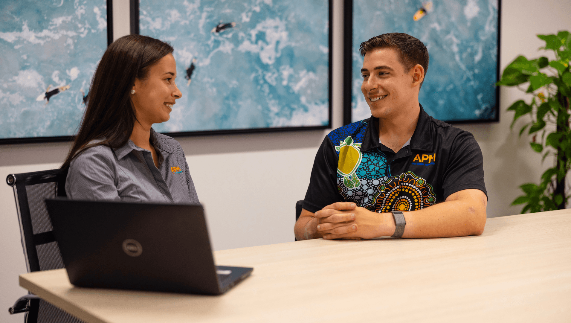 APM team speaks with Tristan in an office boardroom setting