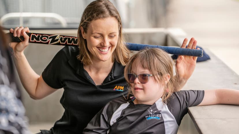 Ellie Cole and a girl with disability at the inclusive hockey event