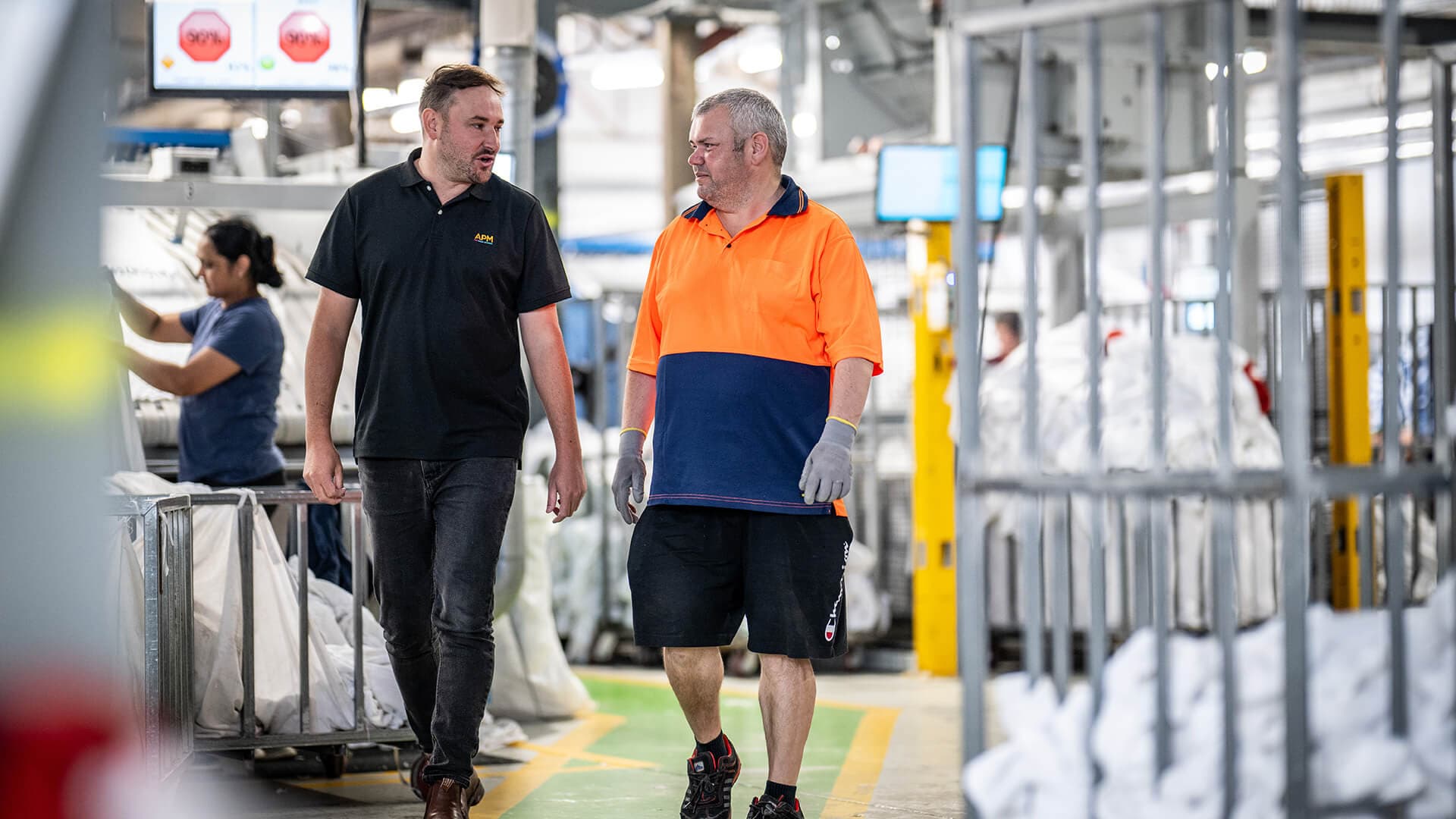 Adam from APM and Geoff walking through the linen workshop