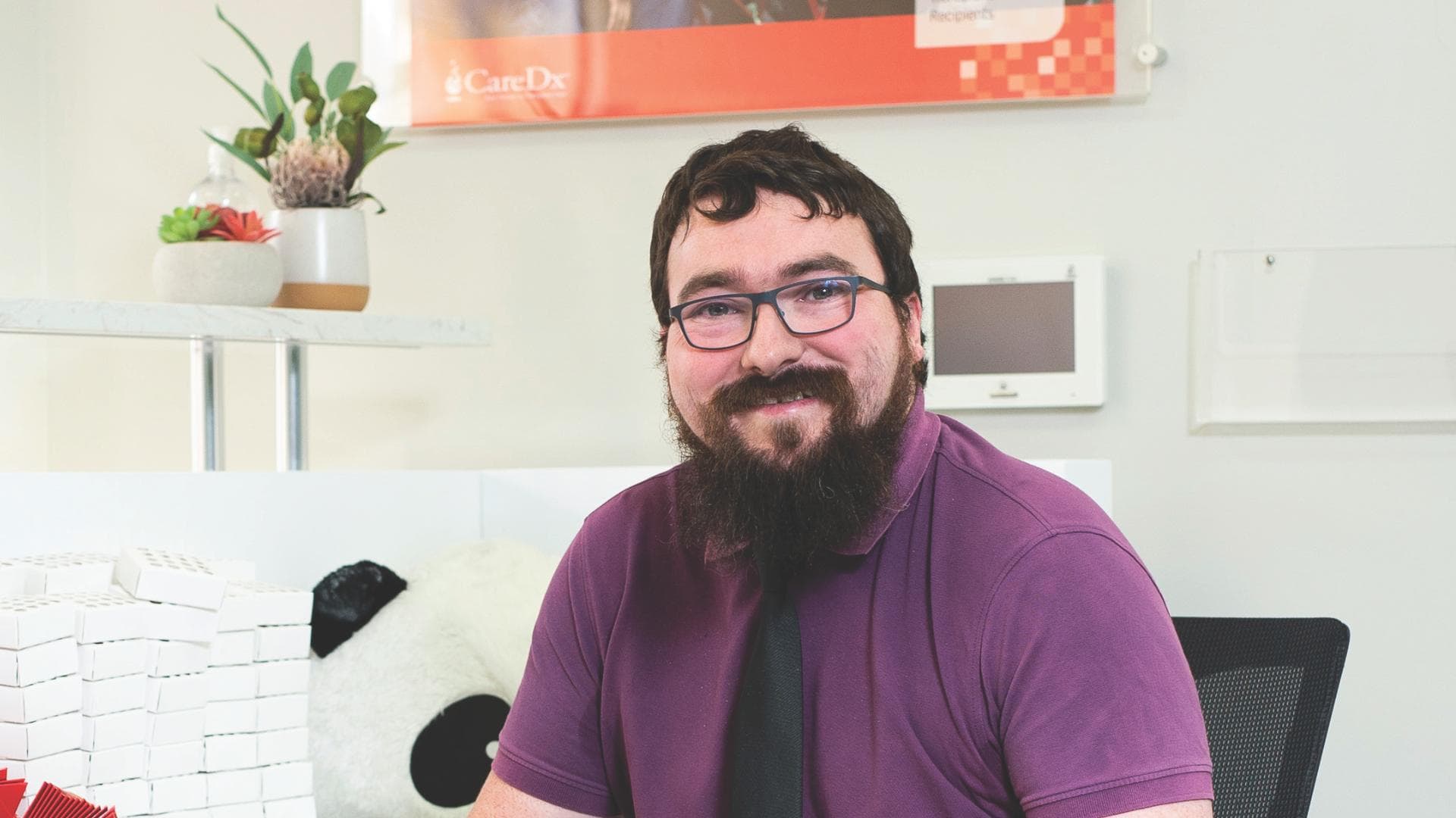 Louis smiles after finding a job in Woolworths