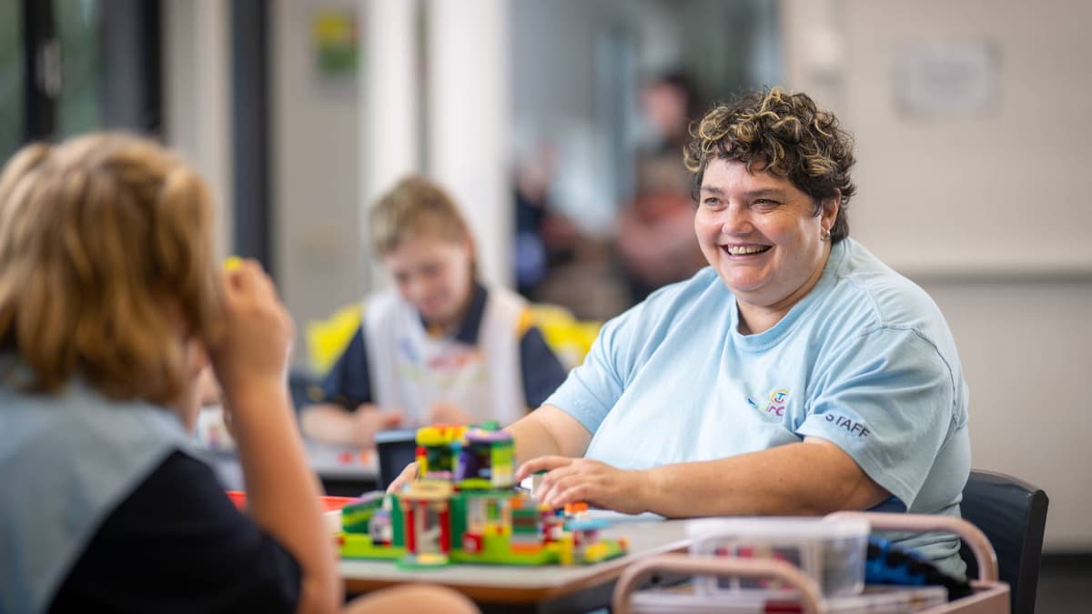 Natalie sat at a table and working with children after school.