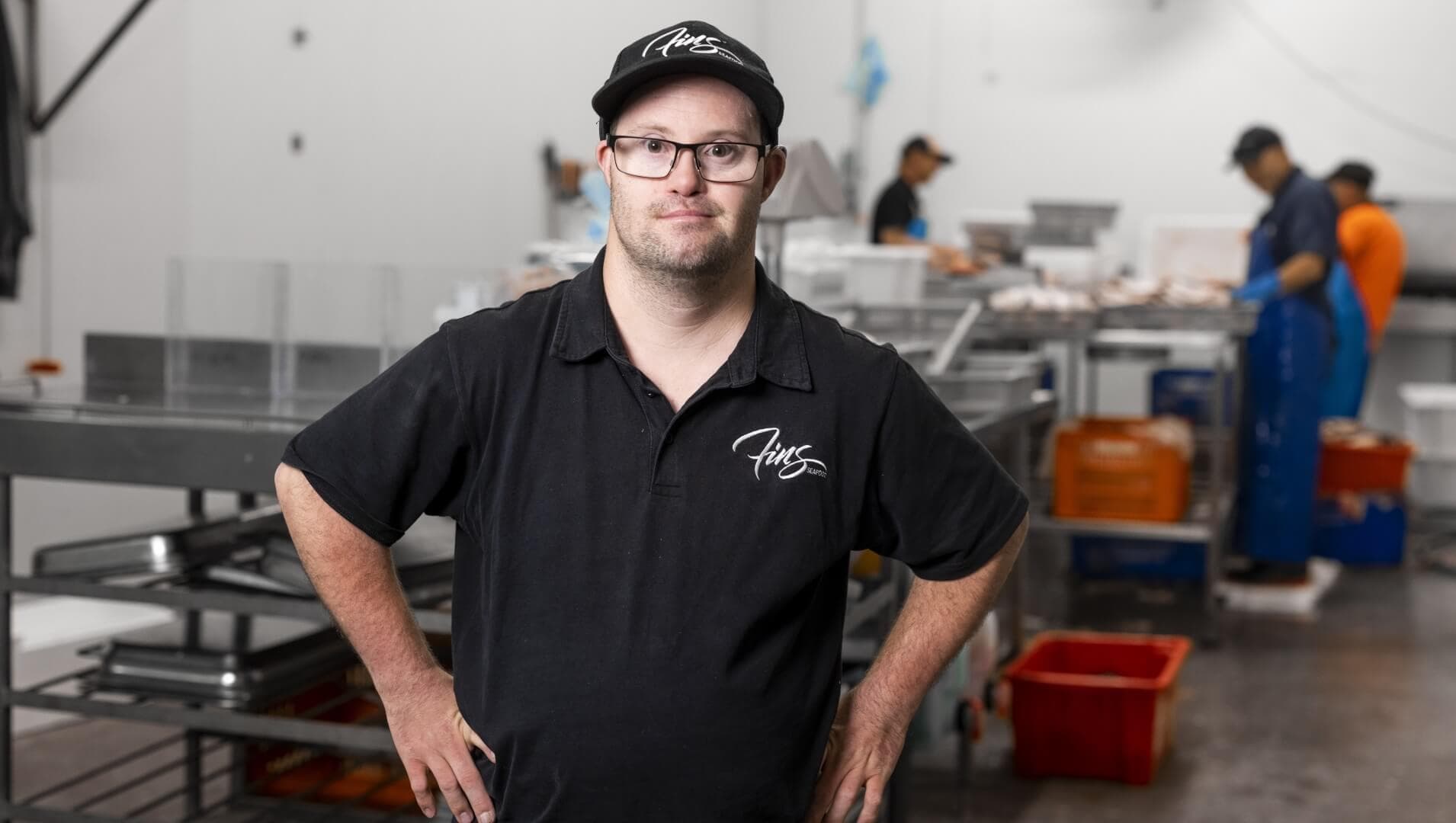 DES participant Shannon standing in workplace with his hands on his hips