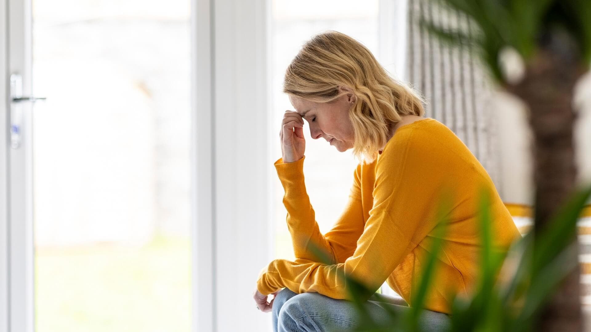 A woman experiencing pain at home