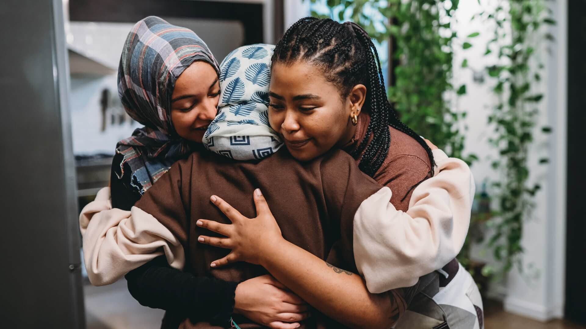 A family supporting each other through a group hug