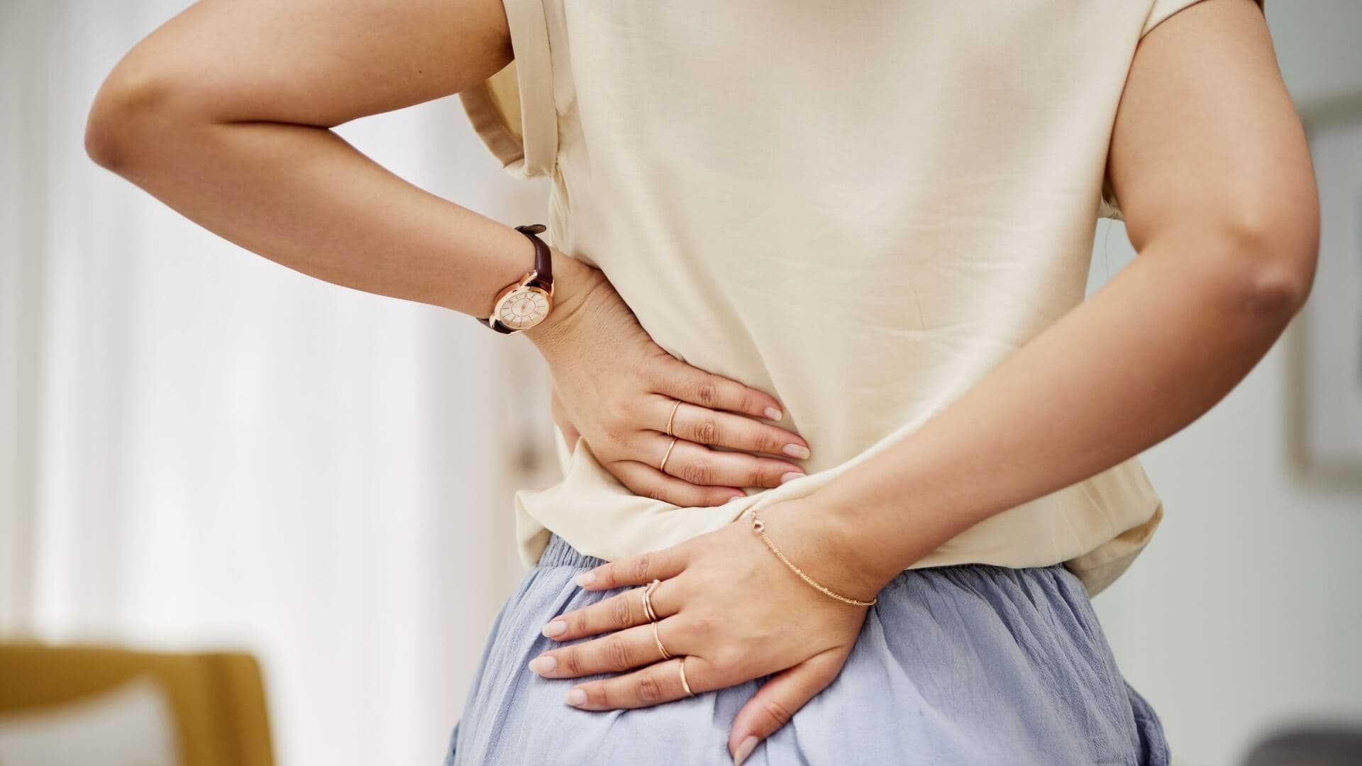 A woman touching her painful back
