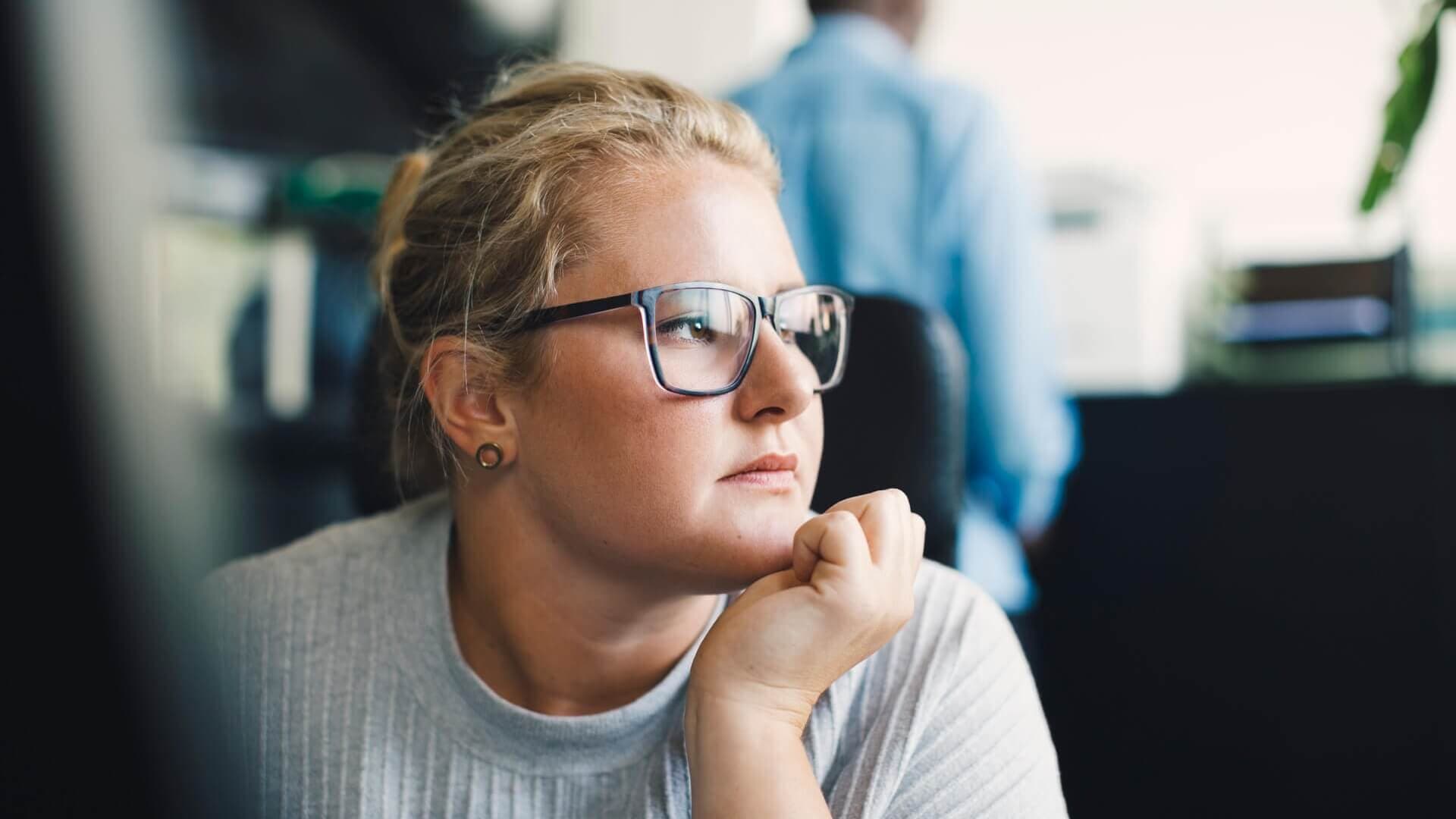 A woman looking off, mid-thought