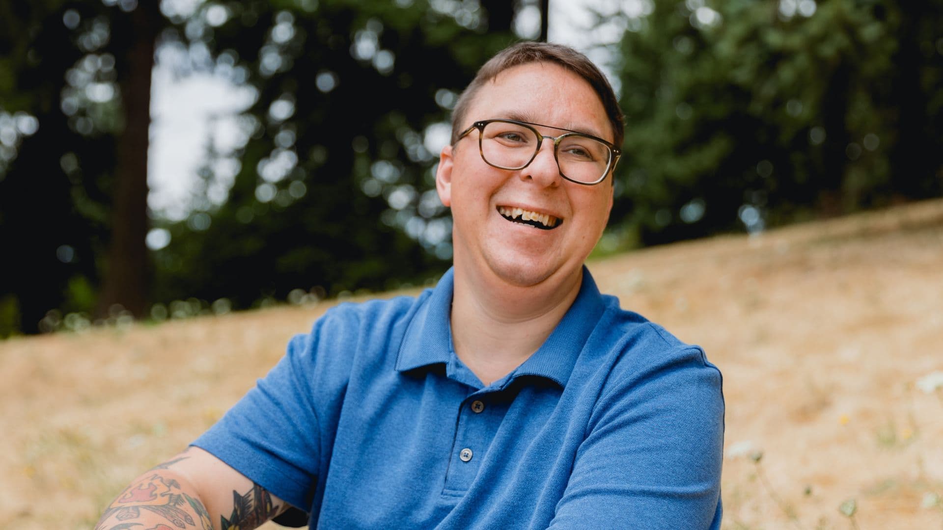 NDIS participant smiling in blue shirt