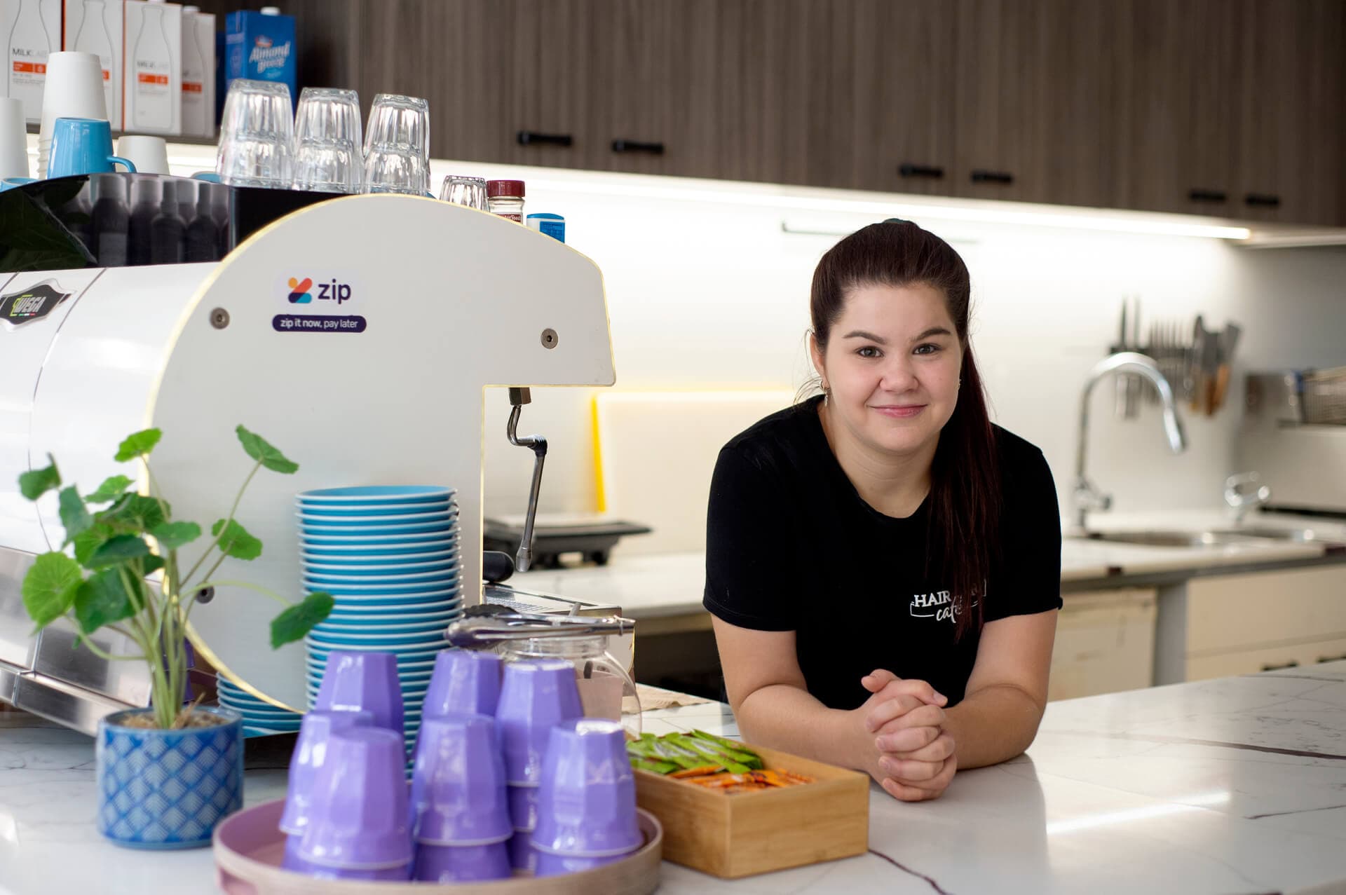 Jessica leaning on a counter smiling