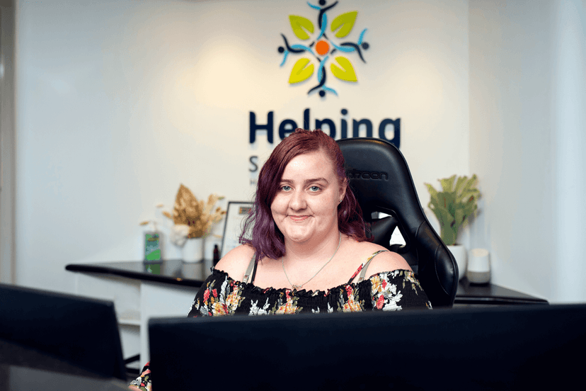 Kristie smiling from behind the reception desk