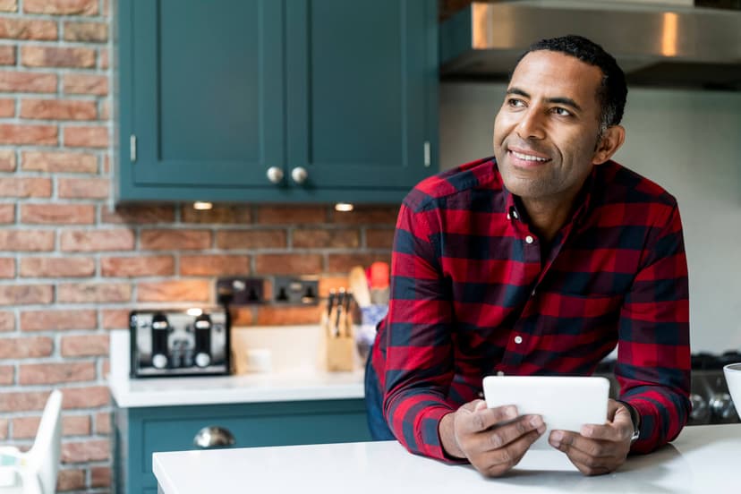Man smiles in brown tshirt