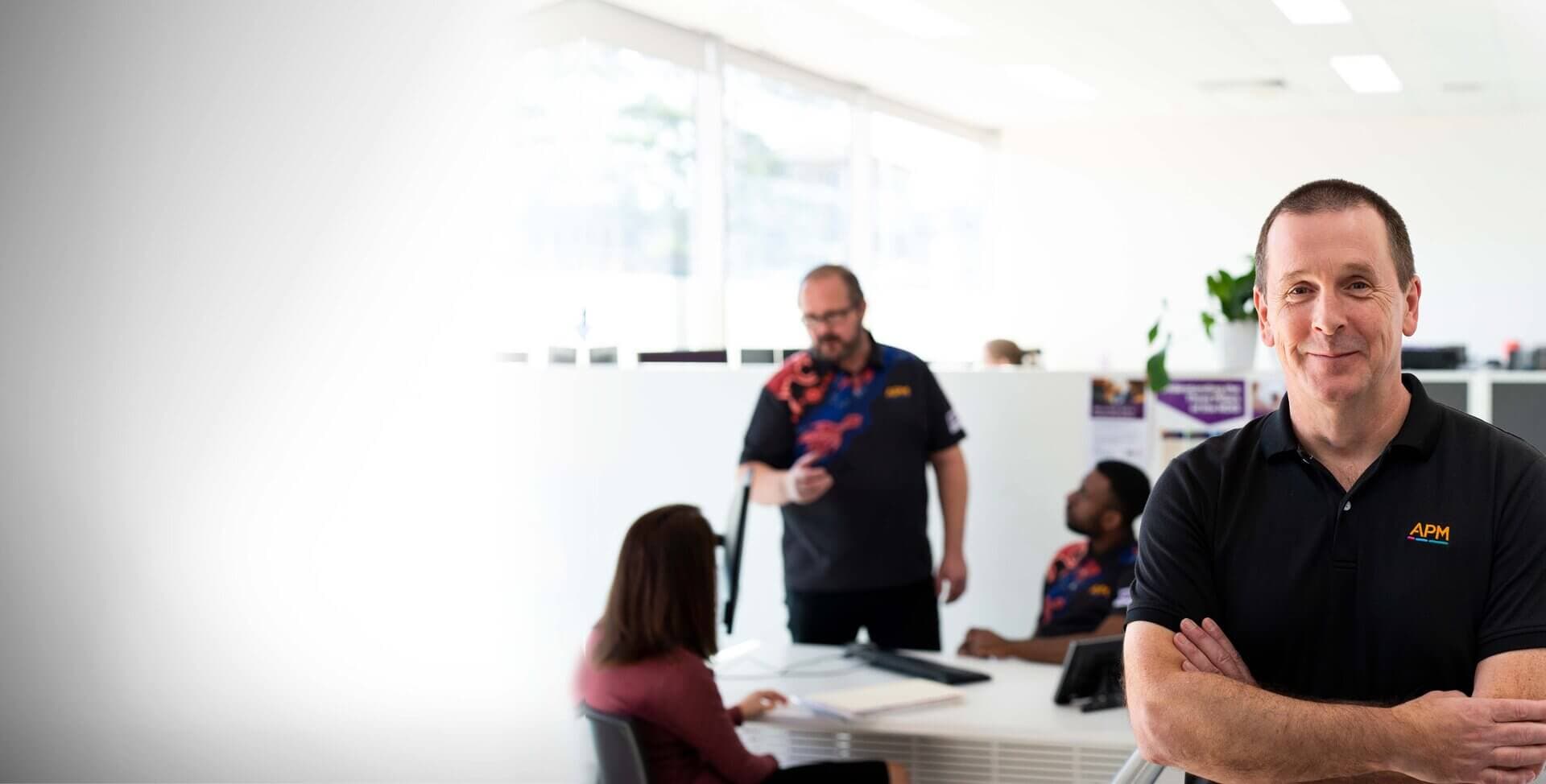 APM employee with folded arms