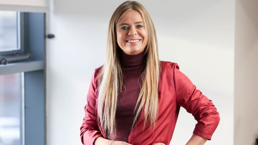 Linzi smiles in a red jacket